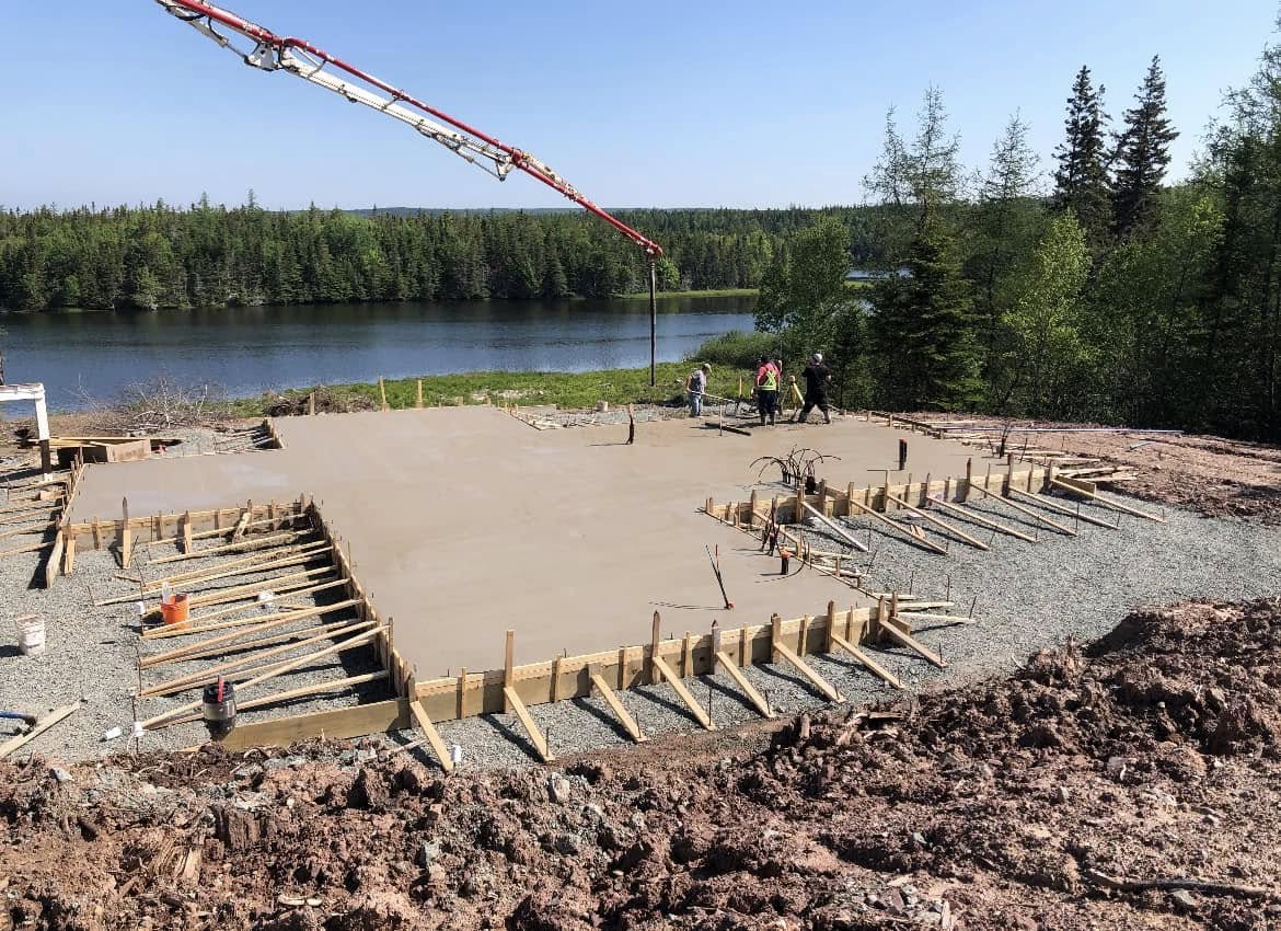 Concrete slab pour in progress with a pump truck on site
